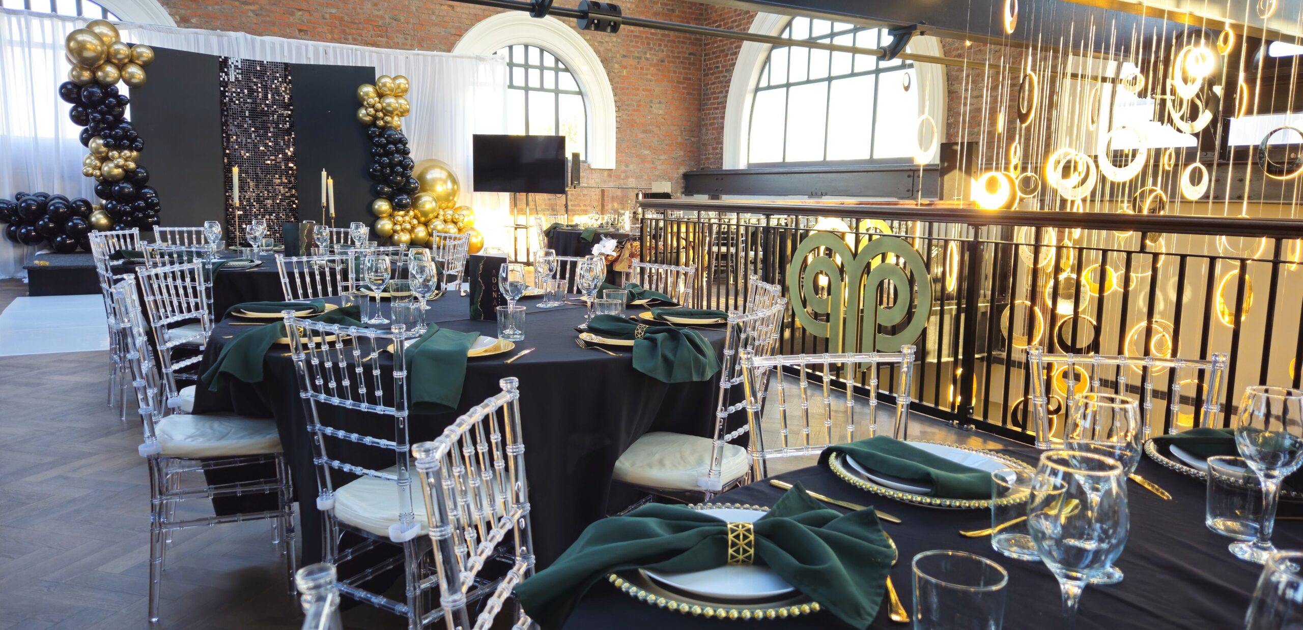 Stunning event setup at Heritage 1907, Ram Mill in Oldham, with gold and black decor, elegant table settings, and a festive atmosphere