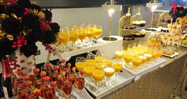Edit7-resized Luxurious catering setup at Heritage 1907, Ram Mill in Oldham, featuring vibrant drinks, desserts, and elegant floral decor for events