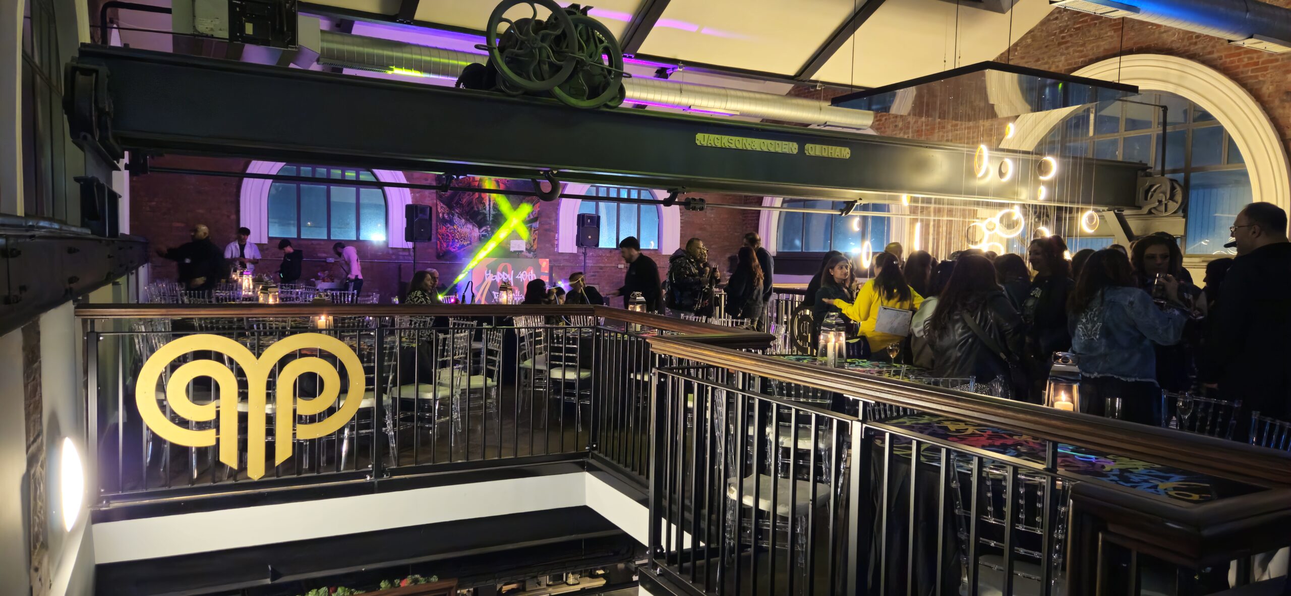 Exciting party at Heritage 1907, Ram Mill in Oldham, with dynamic lighting, industrial decor, and guests enjoying a lively celebration.