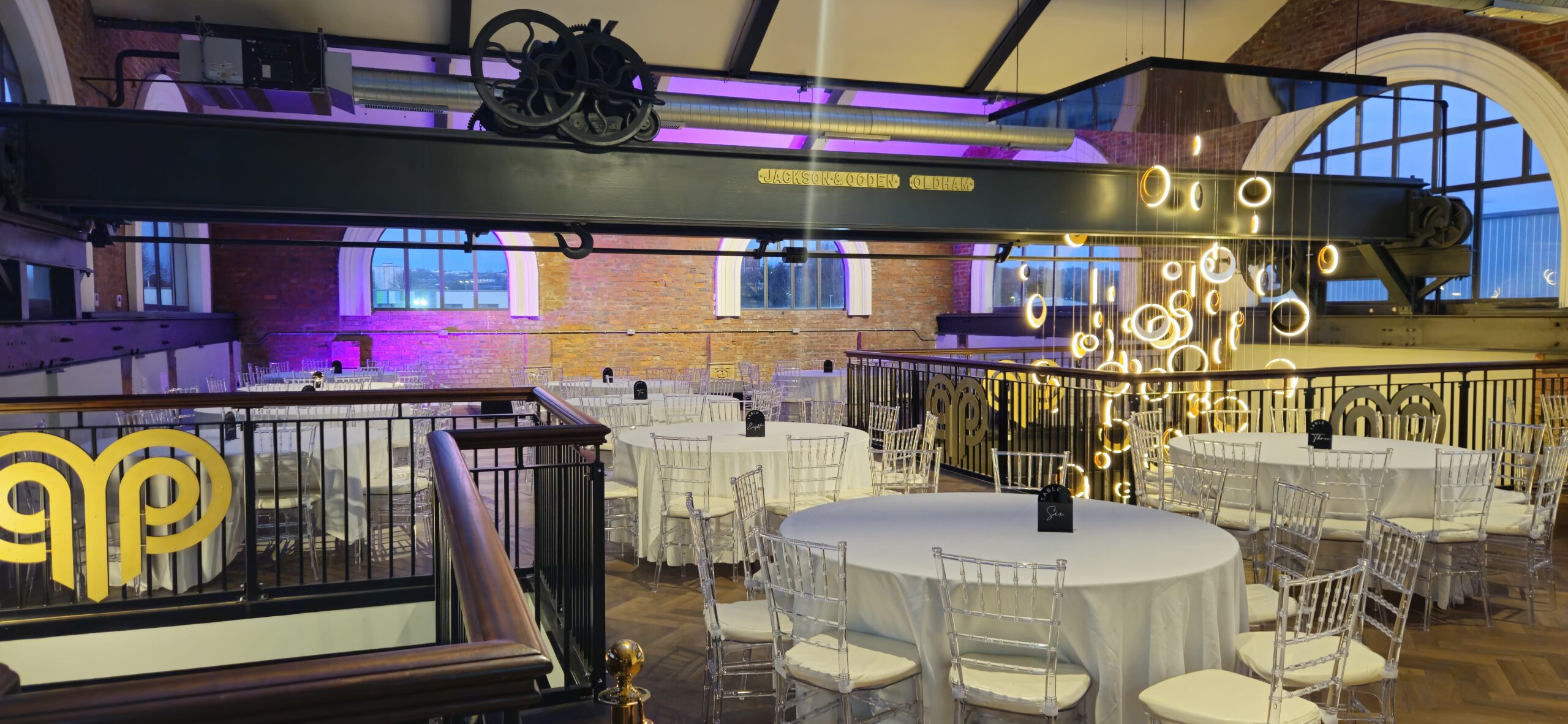 Exciting party at Heritage 1907, Ram Mill in Oldham, with dynamic lighting, industrial decor, and guests enjoying a lively celebration.