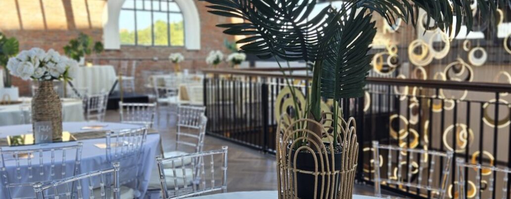 Stunning event setup at Heritage 1907, Ram Mill in Oldham, with gold and black decor, elegant table settings, and a festive atmosphere