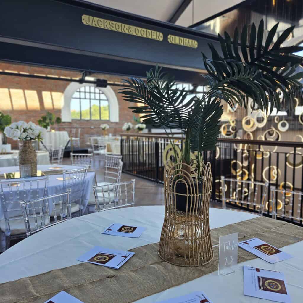Gold and white celebration décor with palms
