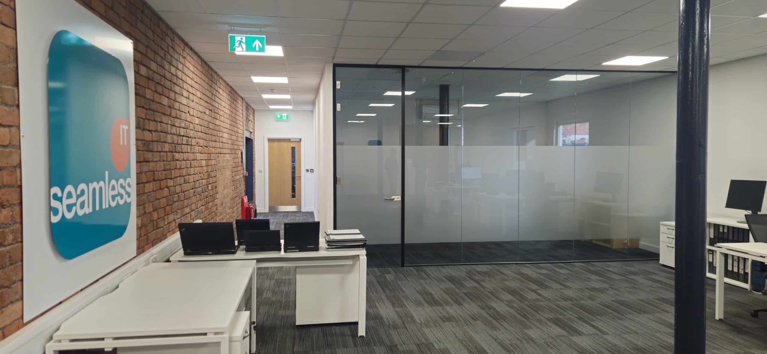 Characterful office space in Oldham at Ram Mill Business Centre, featuring exposed brick walls, natural light, cosy seating areas, and a kitchenette for a comfortable work environment