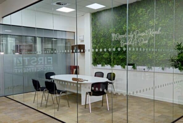 Spacious office rental in Oldham at RamUnique office space in Oldham at Ram Mill Business Centre, featuring exposed brick pillars, a built-in dartboard for breaks, and a bright, open-plan layout for productive work
