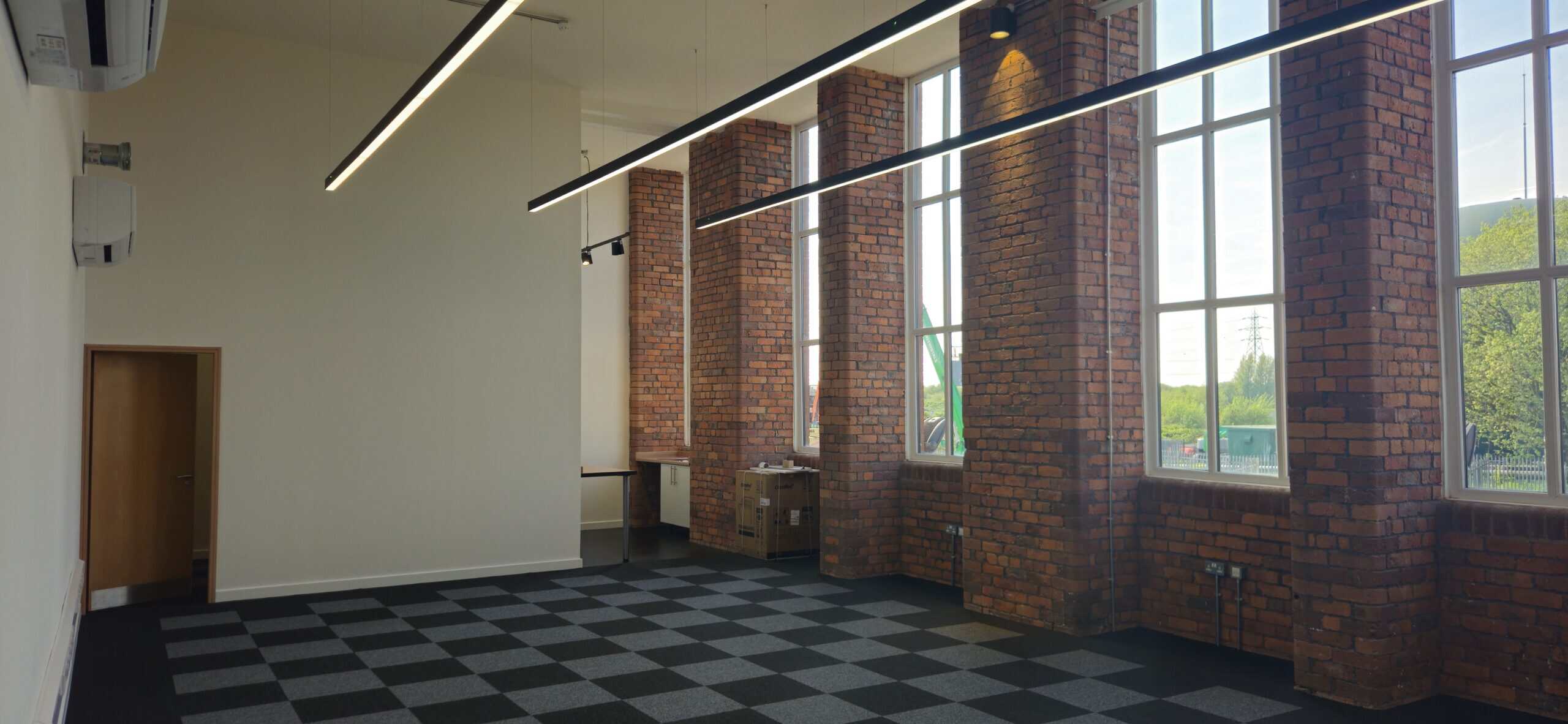 Bright and modern office space available for rent in Oldham at Ram Mill Business Centre, featuring spacious desks, ergonomic chairs, and a collaborative atmosphere
